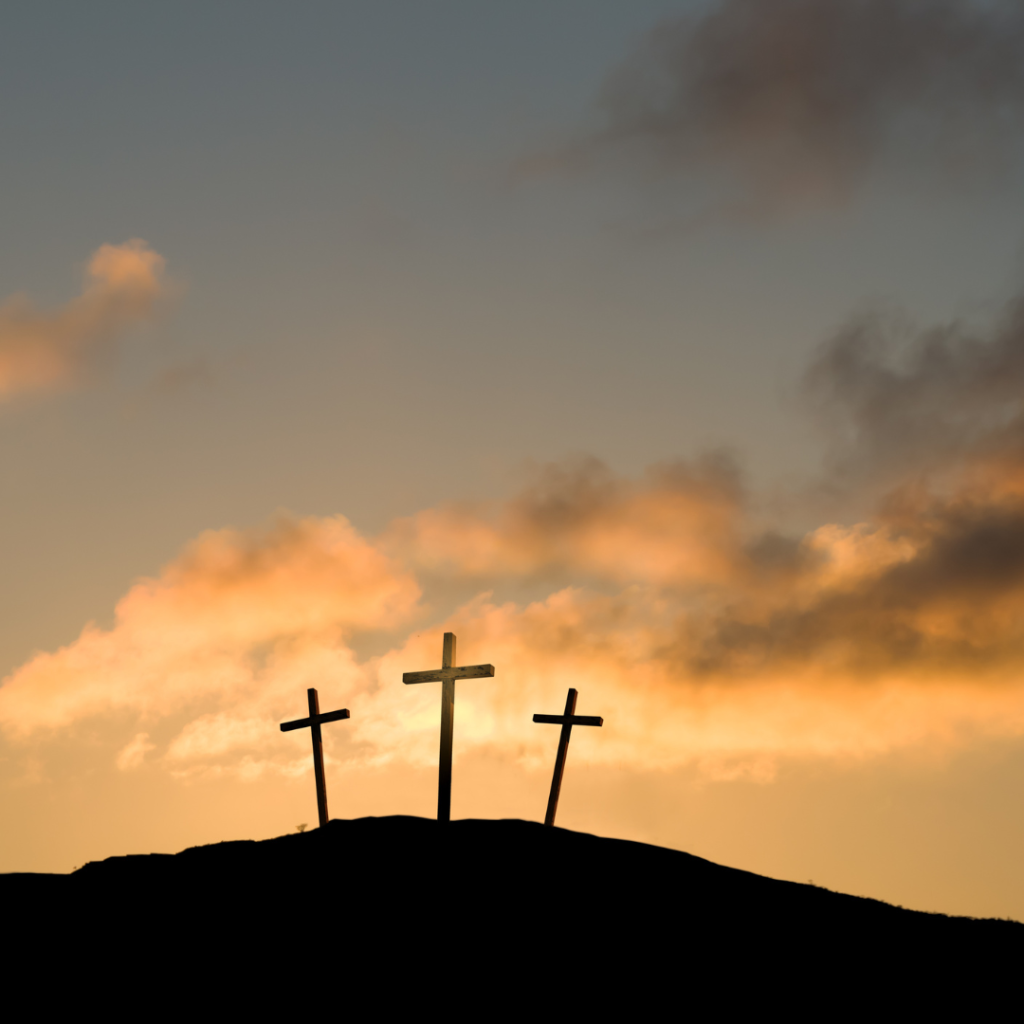 Three crosses against a moody sky